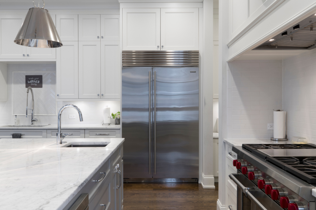 Stainless steel refrigerator in modern white kitchen